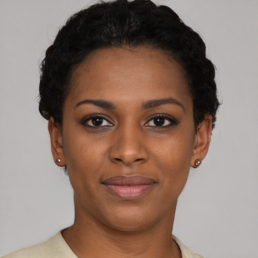 Joyful black young-adult female with short  brown hair and brown eyes