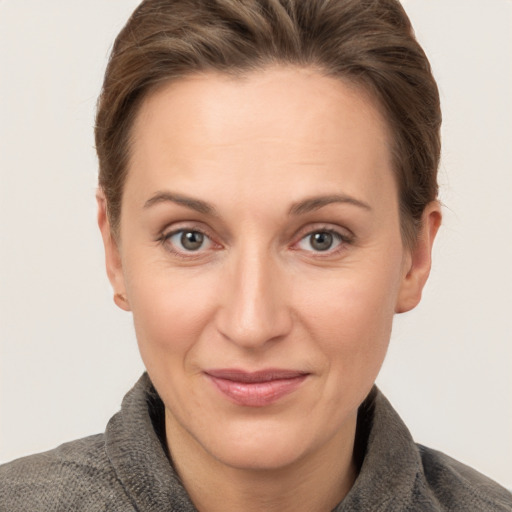 Joyful white adult female with short  brown hair and grey eyes