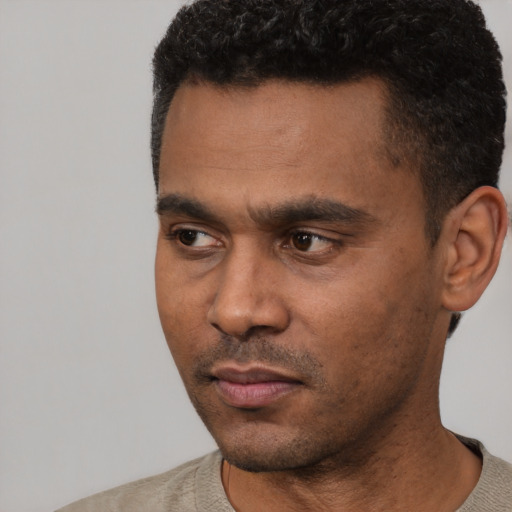 Neutral black young-adult male with short  black hair and brown eyes