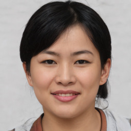 Joyful asian young-adult female with medium  black hair and brown eyes