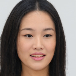 Joyful asian young-adult female with long  brown hair and brown eyes