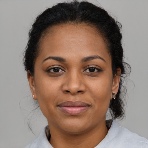 Joyful latino young-adult female with medium  black hair and brown eyes