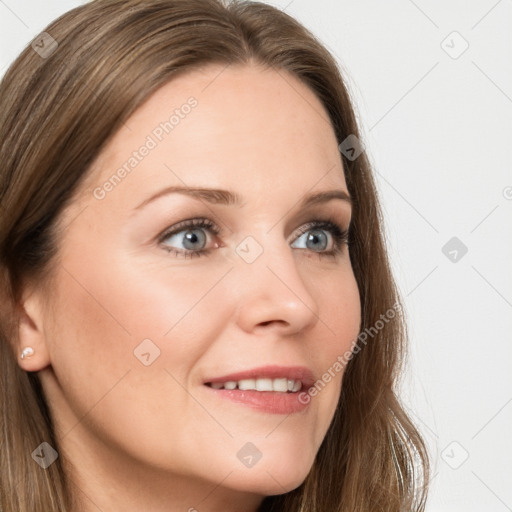 Joyful white young-adult female with long  brown hair and blue eyes