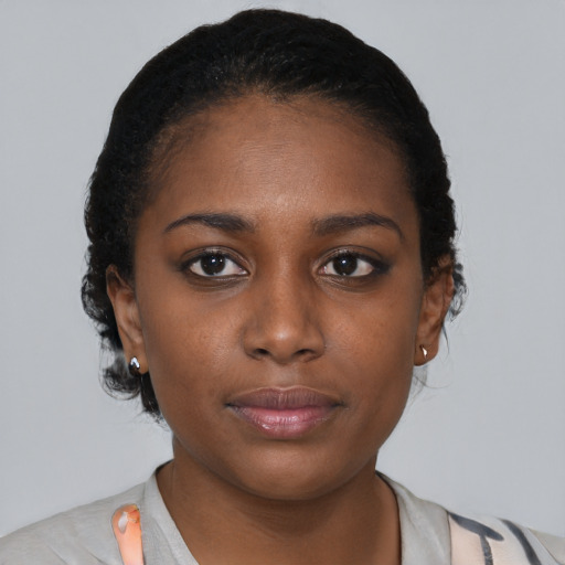 Neutral black young-adult female with medium  brown hair and brown eyes