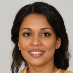 Joyful black young-adult female with medium  brown hair and brown eyes