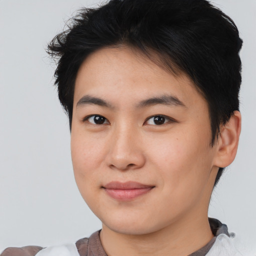 Joyful asian young-adult male with short  black hair and brown eyes