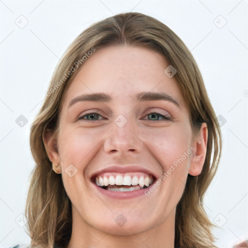 Joyful white young-adult female with medium  brown hair and green eyes