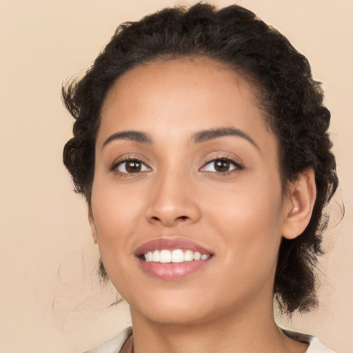 Joyful latino young-adult female with medium  brown hair and brown eyes