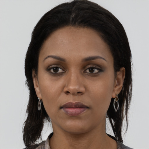 Joyful latino young-adult female with medium  black hair and brown eyes