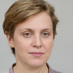 Joyful white adult female with medium  brown hair and grey eyes