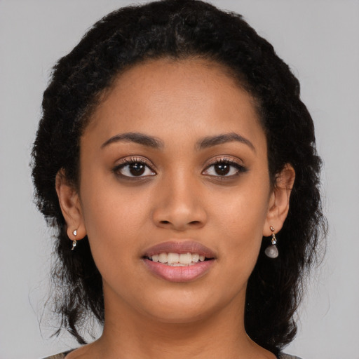 Joyful latino young-adult female with long  black hair and brown eyes