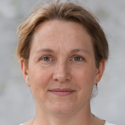 Joyful white adult female with short  brown hair and grey eyes