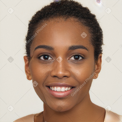 Joyful black young-adult female with short  black hair and brown eyes