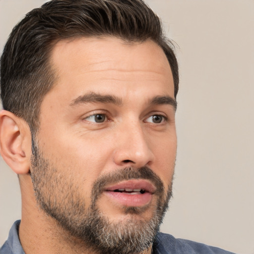 Joyful white adult male with short  brown hair and brown eyes