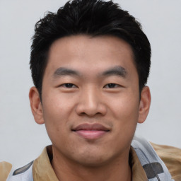 Joyful asian young-adult male with short  black hair and brown eyes