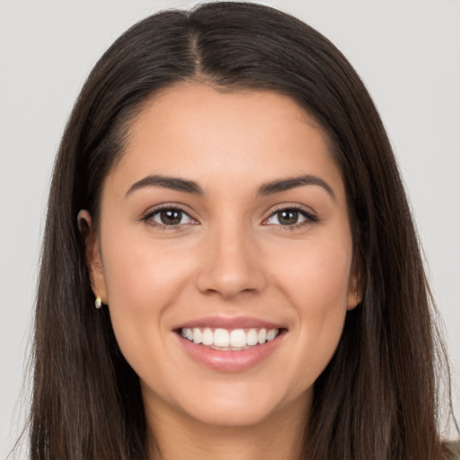 Joyful white young-adult female with long  brown hair and brown eyes