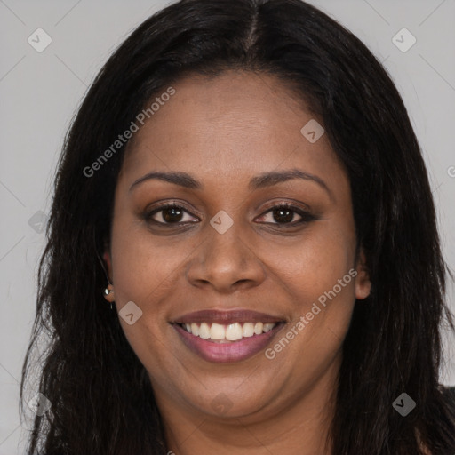 Joyful black young-adult female with long  brown hair and brown eyes