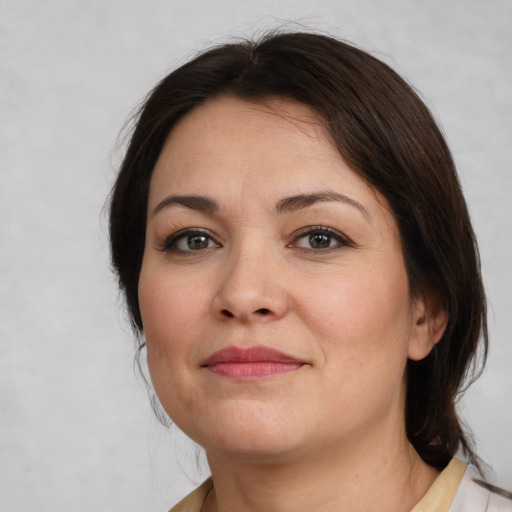 Joyful white young-adult female with medium  brown hair and brown eyes