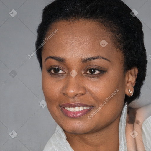 Joyful black young-adult female with short  black hair and brown eyes