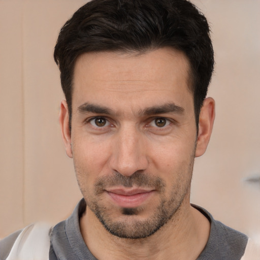 Joyful white young-adult male with short  black hair and brown eyes