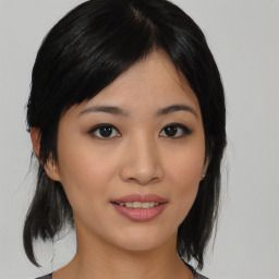 Joyful asian young-adult female with medium  black hair and brown eyes