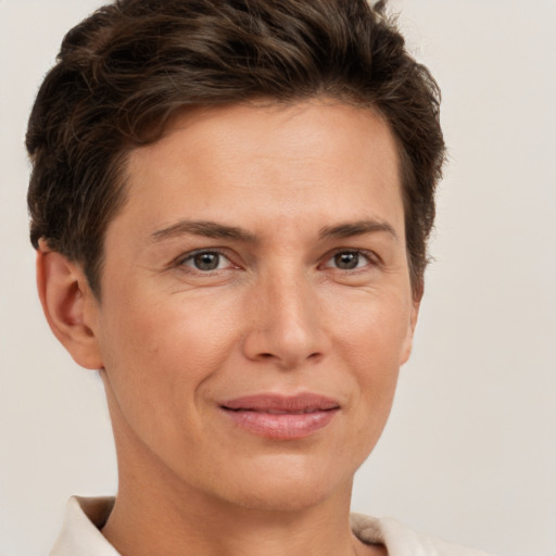 Joyful white adult female with short  brown hair and brown eyes