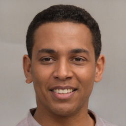 Joyful latino young-adult male with short  brown hair and brown eyes