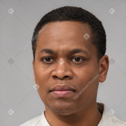 Joyful black adult male with short  black hair and brown eyes