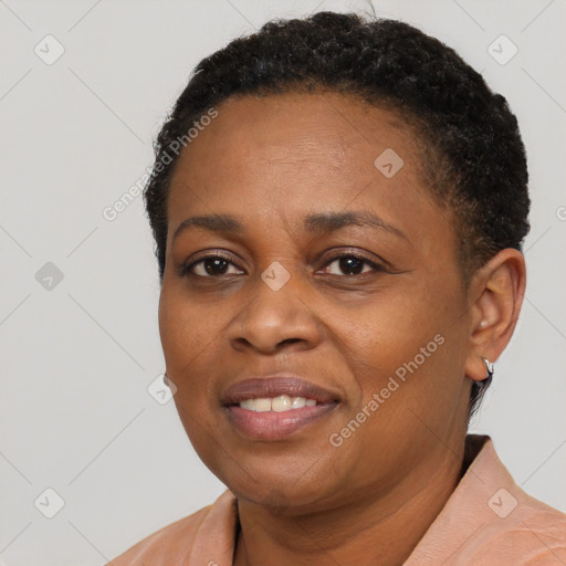 Joyful black adult female with short  brown hair and brown eyes