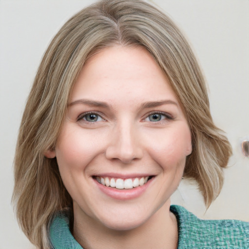 Joyful white young-adult female with medium  brown hair and green eyes