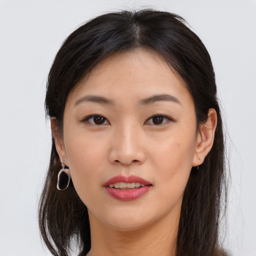 Joyful asian young-adult female with long  brown hair and brown eyes
