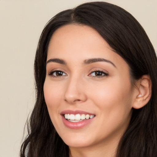 Joyful white young-adult female with long  black hair and brown eyes