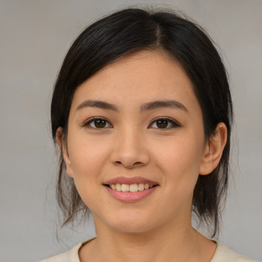Joyful white young-adult female with medium  brown hair and brown eyes
