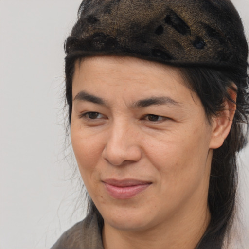 Joyful latino adult female with medium  brown hair and brown eyes