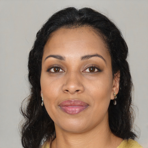 Joyful black young-adult female with medium  brown hair and brown eyes