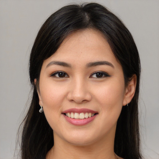 Joyful asian young-adult female with long  brown hair and brown eyes