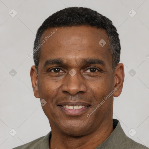 Joyful black adult male with short  black hair and brown eyes