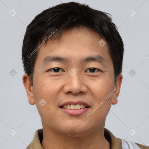 Joyful asian young-adult male with short  brown hair and brown eyes