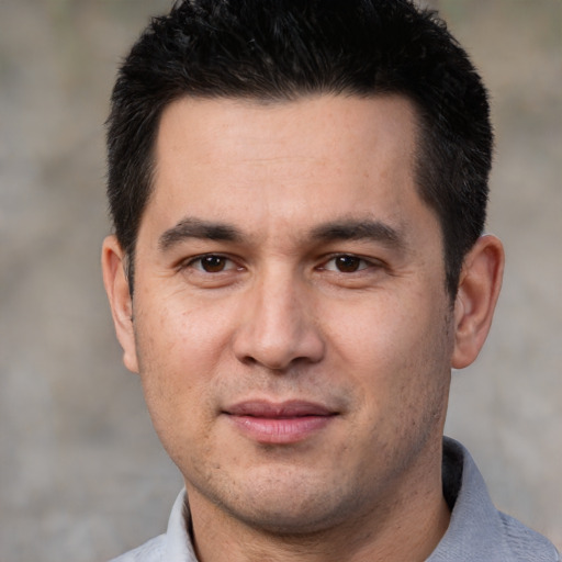 Joyful white adult male with short  black hair and brown eyes