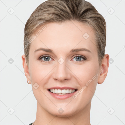 Joyful white young-adult female with short  brown hair and grey eyes