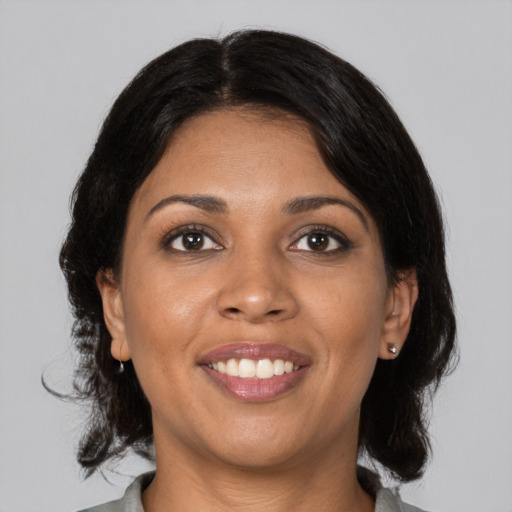 Joyful black young-adult female with medium  black hair and brown eyes