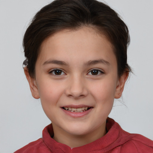 Joyful white child female with short  brown hair and brown eyes