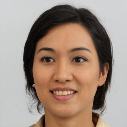 Joyful asian young-adult female with medium  brown hair and brown eyes