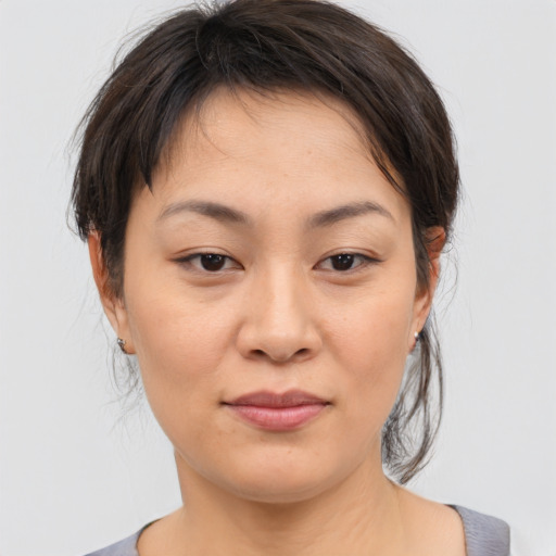 Joyful asian young-adult female with medium  brown hair and brown eyes