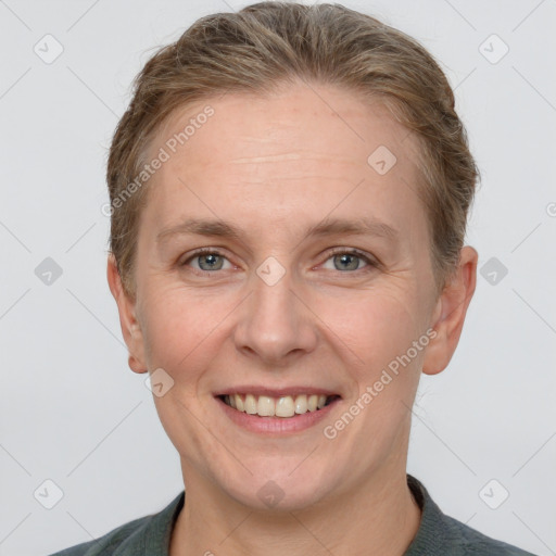 Joyful white adult female with short  brown hair and grey eyes