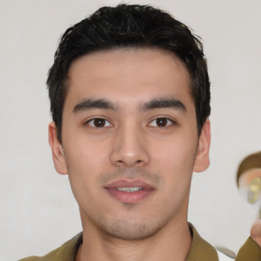 Joyful white young-adult male with short  black hair and brown eyes