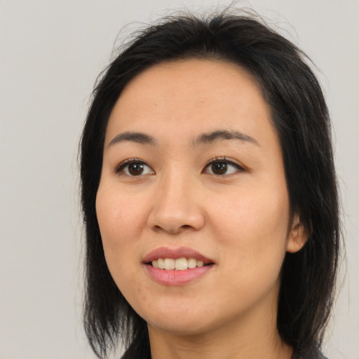 Joyful asian young-adult female with medium  brown hair and brown eyes