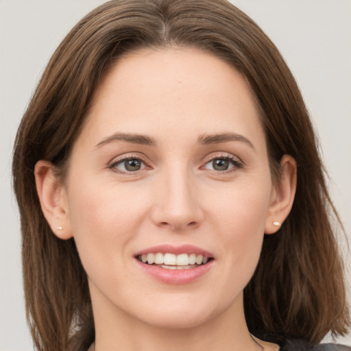 Joyful white young-adult female with long  brown hair and grey eyes