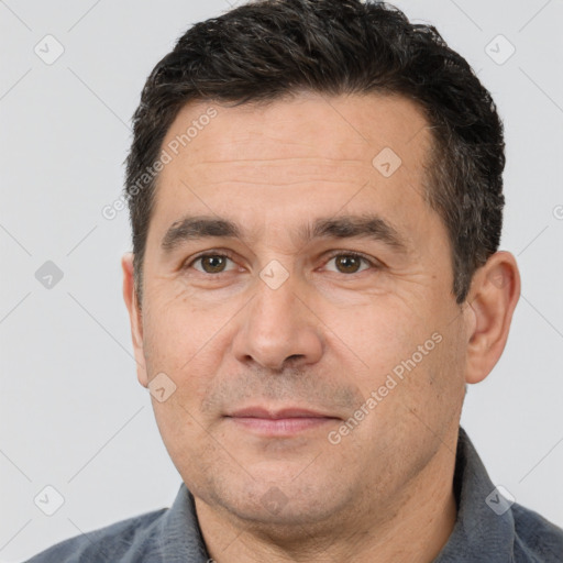 Joyful white adult male with short  brown hair and brown eyes