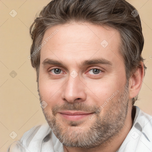 Joyful white adult male with short  brown hair and brown eyes